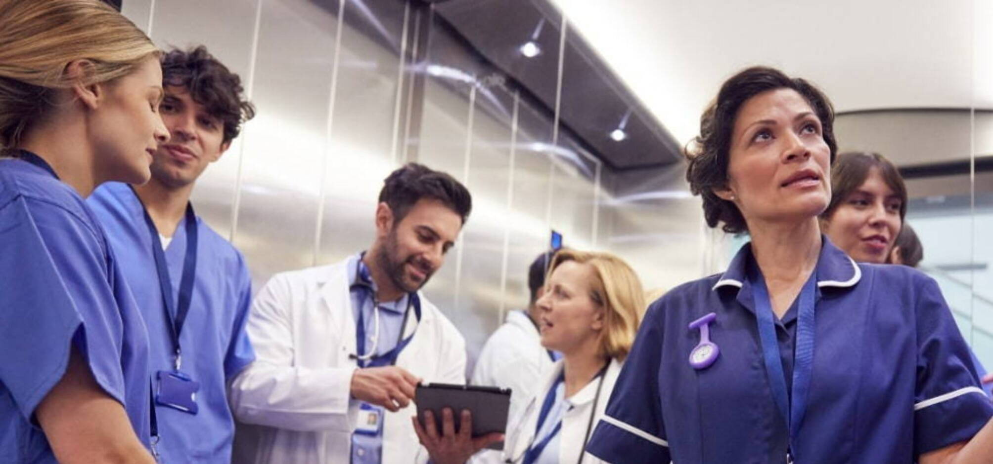 team of medgen recruits gathering around an elevator