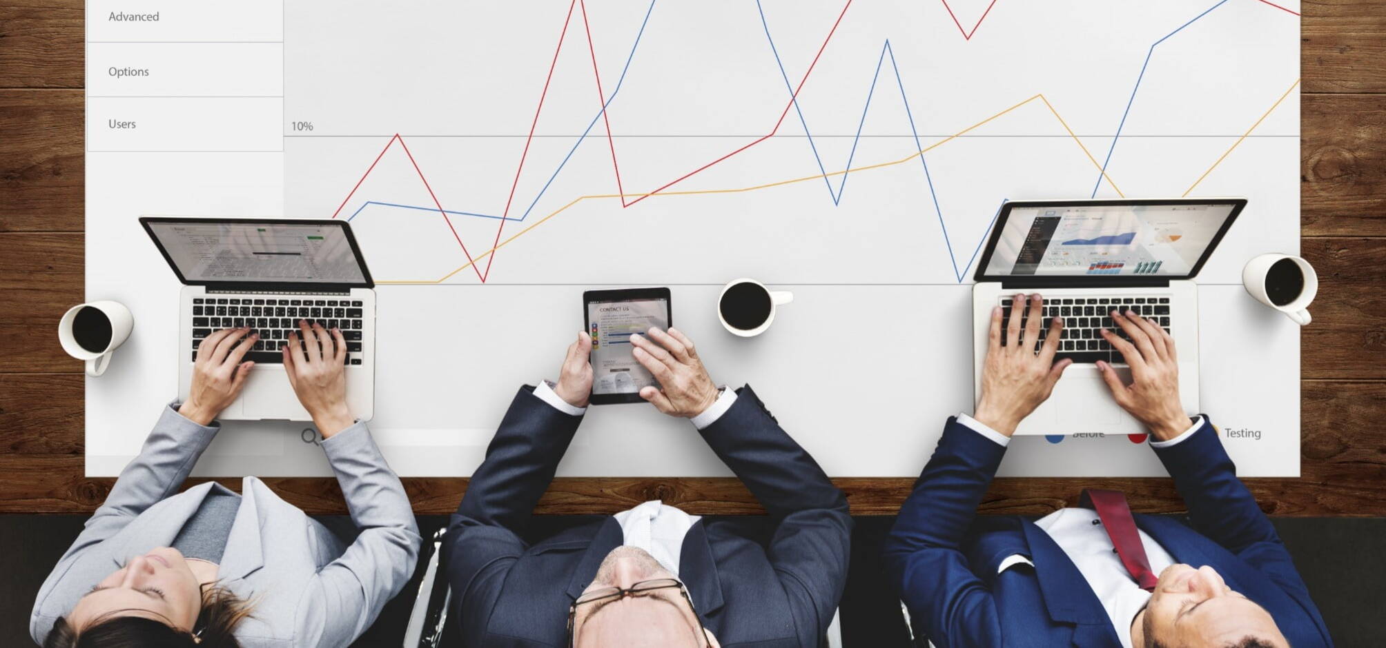 three recruiters working next to each other on a desk with a graph spread on the table